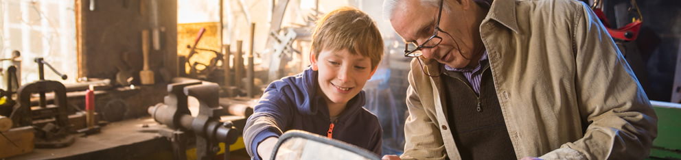 Man and child working in a garage