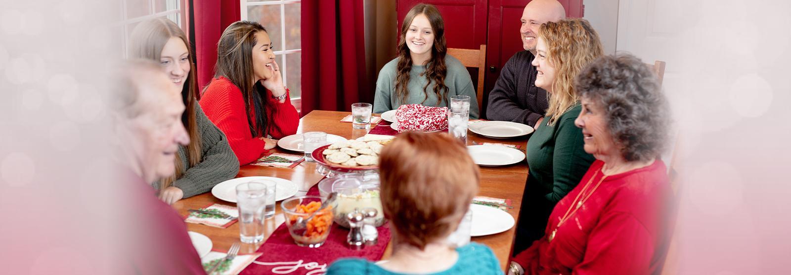 family at dinner table for holidays