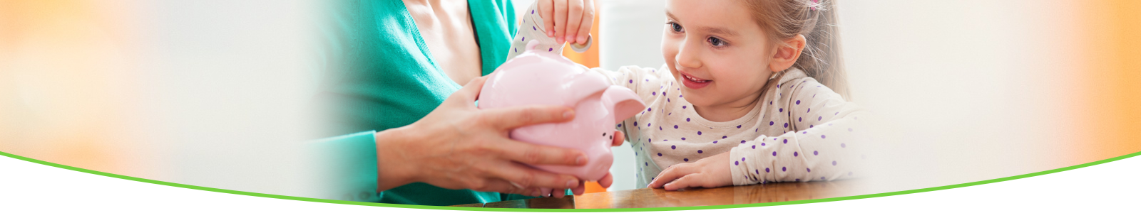 Child putting money in a piggy bank