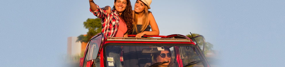 Women standing in a car